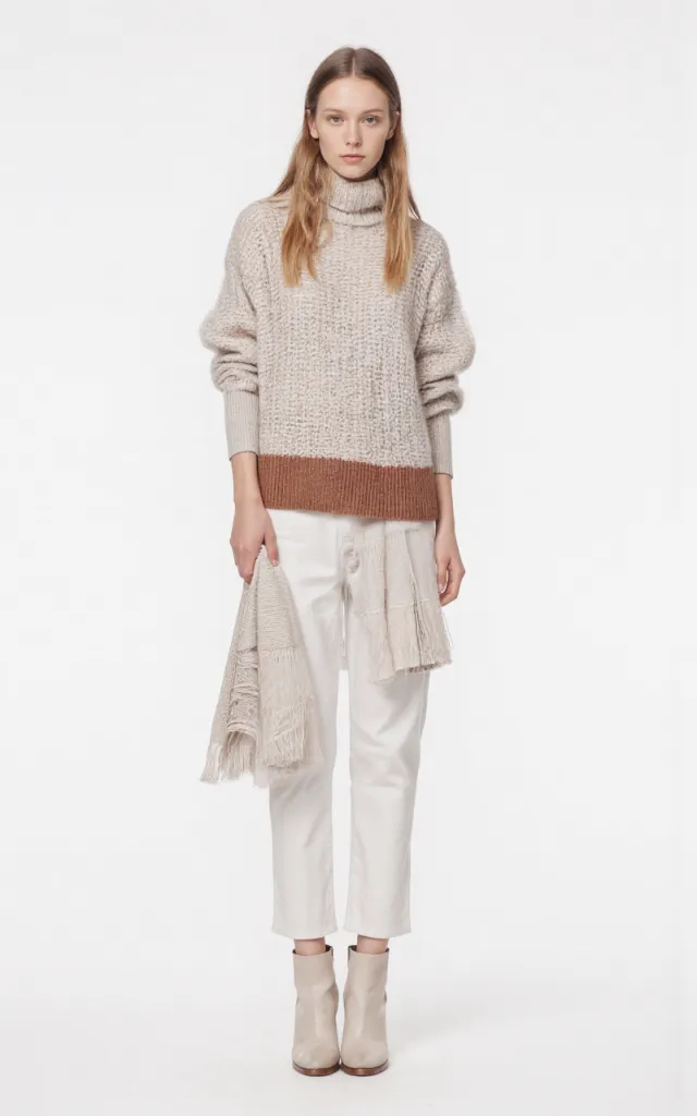 A French female model wearing Scandinavian   style clothing, against a white background, in a front   facing shot focusing on shoes